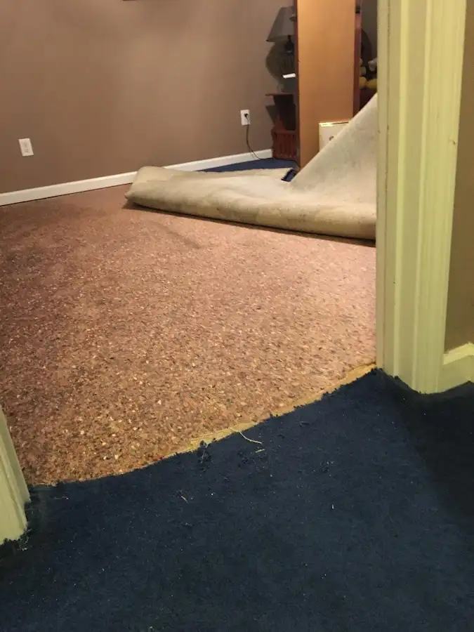 Carpet pad removal revealing water damage during Drying & Dehumidification in Cushing