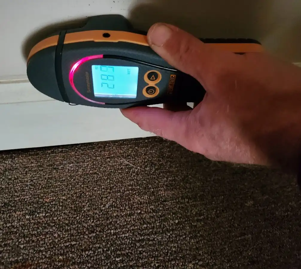Moisture detection at baseboard during Storm Damage Restoration in Cushing